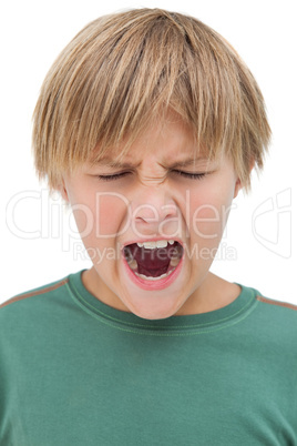 Furious little boy shouting with eyes closed