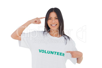 Smiling woman pointing to her volunteer tshirt