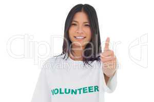 Pretty volunteer woman with thumb up