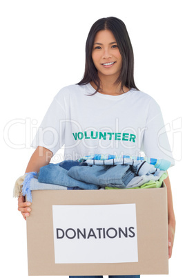Happy woman carrying donation box
