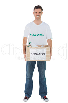 Handsome man carrying donation box with bottles