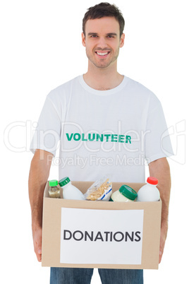 Handsome man carrying donation box with food