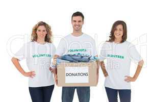 Smiling group of volunteers holding donation box