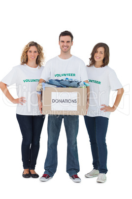 Group of volunteers holding donation box with clothes