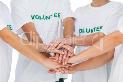 Group of volunteers putting hands together