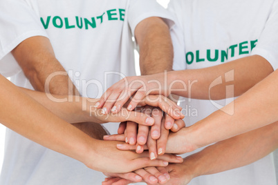 Volunteers piling up their hands together