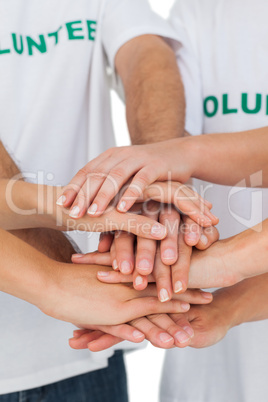 Volunteers putting hands together