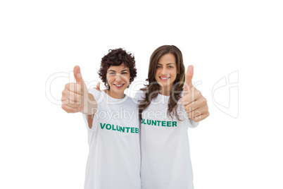 Two happy volunteers giving thumbs up