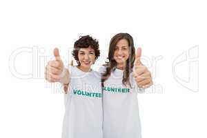 Two happy volunteers giving thumbs up