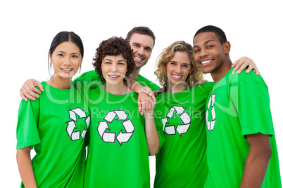 Group of people wearing green shirt with recycling symbol on it