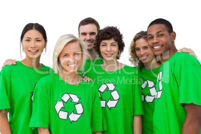 Group of smiling activists wearing green shirt with recycling sy