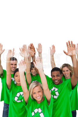 Cheerful group of environmental activists raising arms