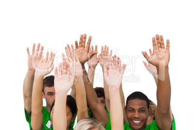 Smiling group of people raising arms