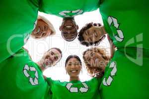 Low angle view of people wearing green shirt with recycling symb