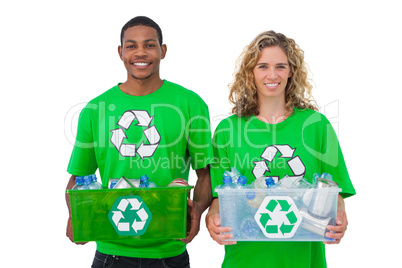Two  cheerful environmental activists holding box of recyclables