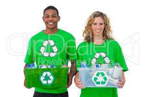 Two  cheerful environmental activists holding box of recyclables