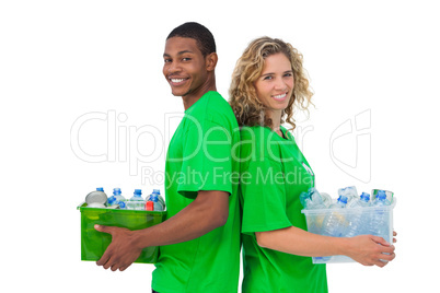 Cheerful environmental activists holding box of recyclables and