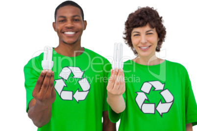 Two environmental activists holding light bulbs