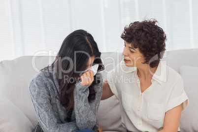 Patient crying next to her therapist