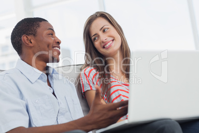 Cheerful creative designers working together on a laptop