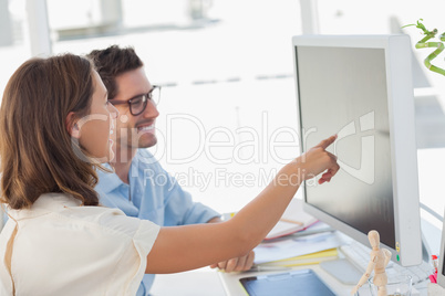 Attractive photo editor pointing at the screen