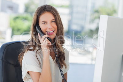 Cheerful businesswoman having a phone conversation