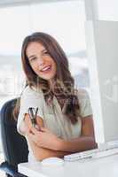 Businesswoman smiling at her desk