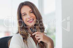 Businesswoman posing while she is holding her reading glasses