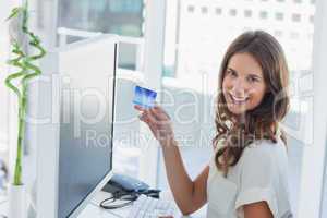 Cheerful brunette designer purchasing online