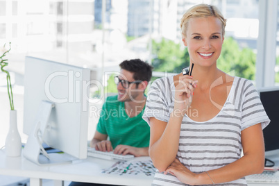 Pretty designer posing in his office