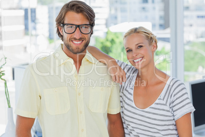 Attractive designer leaning on the colleagues shoulder