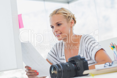 Pretty photo editor looking at a contact sheet