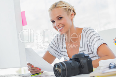 Blonde photo editor holding a contact sheet