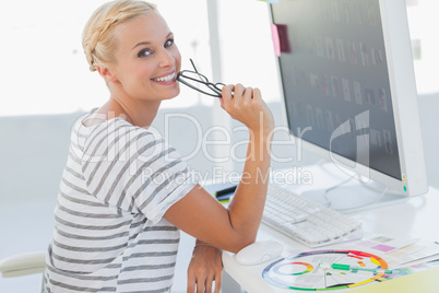 Attractive photo editor at her desk