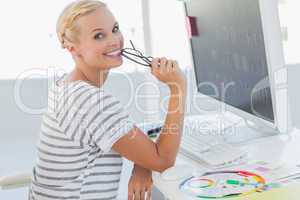 Attractive photo editor at her desk