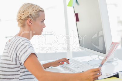 Attractive photo editor looking at a document
