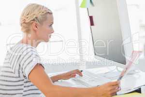 Attractive photo editor looking at a document