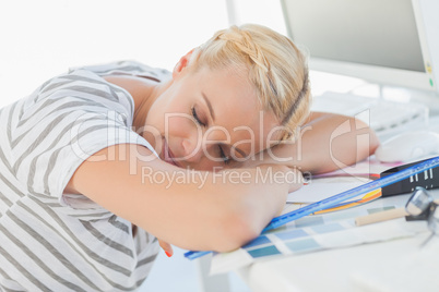 Overworked blonde designer napping on her desk