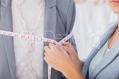 Fashion designer measuring blazer