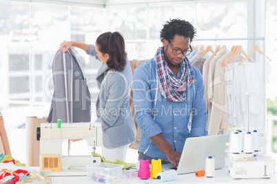 Fashion designer working on laptop