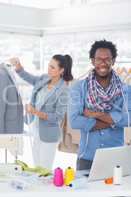 Handsome fashion designer with arms crossed