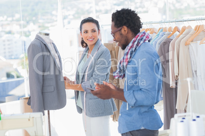 Fashion designers adjusting blazer