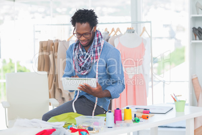 Fashion designer using digital tablet