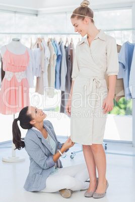 Fashion designer sitting next to a model