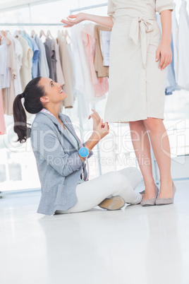 Fashion designer talking to model