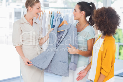 Smiling women holding a blazer