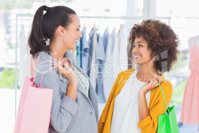 Smiling women holding shopping bags