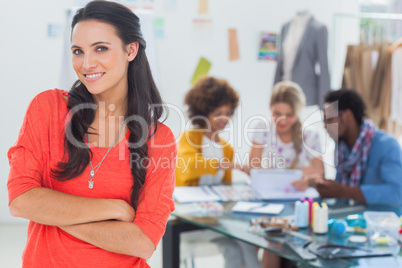 Smiling fashion designer with arms crossed