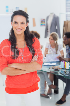 Pretty fashion designer with arms crossed in bright office