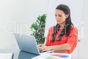 Pretty designer working on her laptop